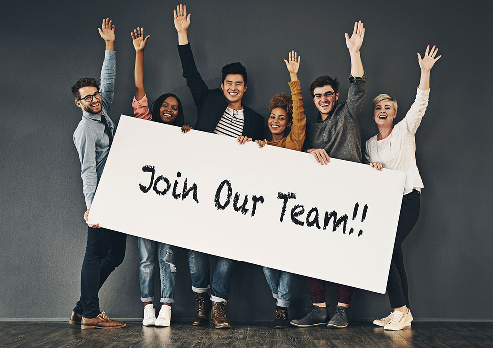 Group of people holding Join Our Team sign