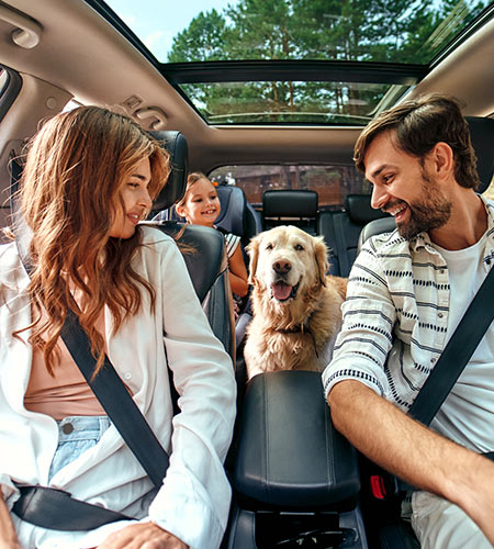 Parents, child and dog in car.