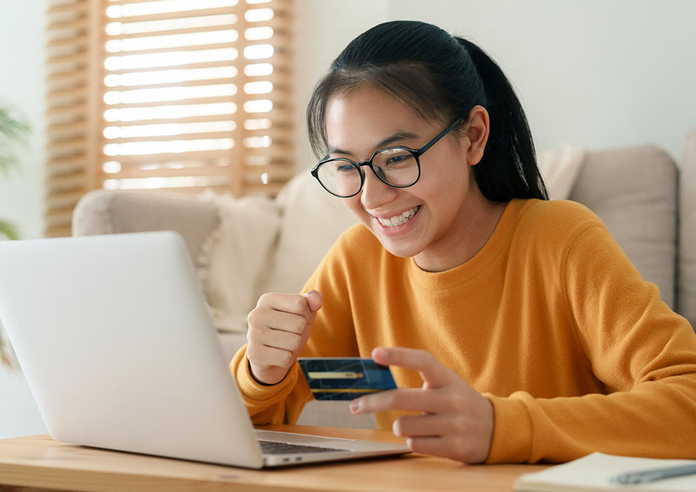 Girl using card with laptop